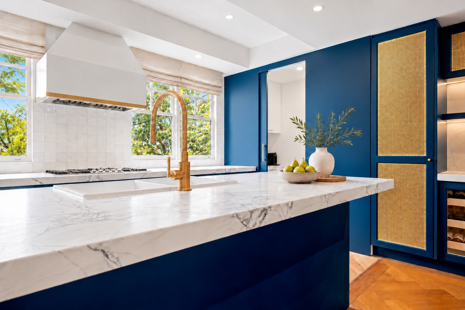 Navy kitchen cabinetry with gold mesh doors