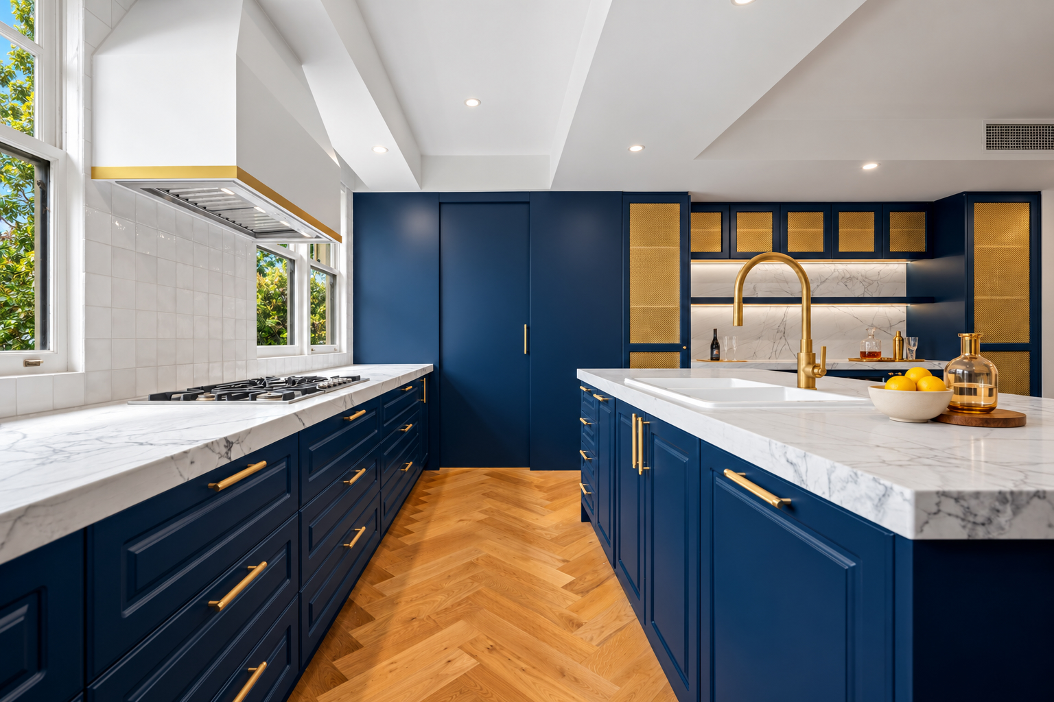 Navy kitchen with brass bar accents and Kintore Pull handles